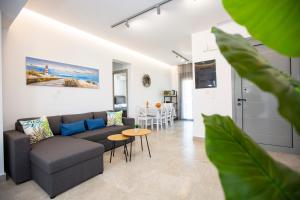a living room with a couch and a table at SoL Apt Faliraki in Faliraki