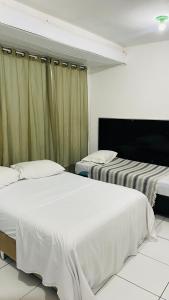 Ένα ή περισσότερα κρεβάτια σε δωμάτιο στο Suite Proximo a Praia