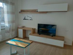 a living room with a tv and a coffee table at Appartamento il legno di mare in La Spezia