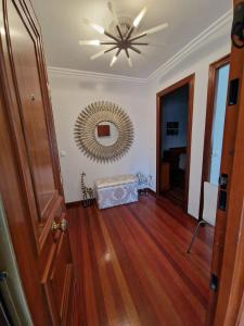 a hallway with a ceiling fan and a mirror at Alojamiento Alameda in Redondela