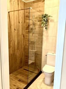 een badkamer met toilet en glazen douche bij NEW: Summerhouse near beach&lake in Noordwijkerhout +16 foto's