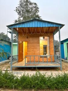 古爾岡的住宿－Farm with 5 huts, heated pool and bonfire，蓝色屋顶的小房子