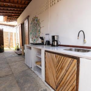a kitchen with a sink and a counter top at Casa aloha in Atins +11 photos