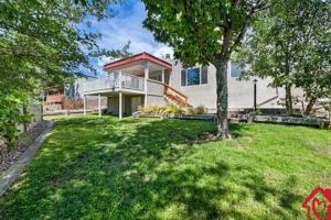 a large house with a tree in the yard at Desert Skyline Getaway - An Irvie Home in Tijeras