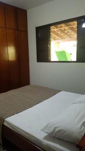 A bed or beds in a room at Quarto Quádruplo
