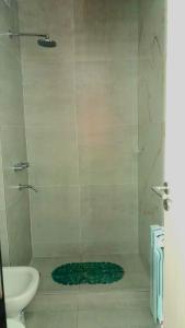 a bathroom with a shower with a toilet and a sink at Villa María in Villa María