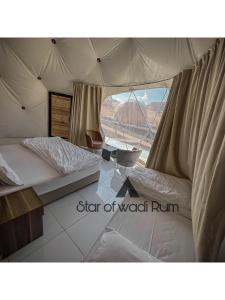 a bedroom with two beds in a tent at STAR of Wadi Rum in Wadi Rum