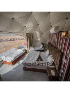 a bedroom with two beds in a tent at STAR of Wadi Rum in Wadi Rum