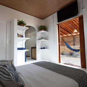 a bedroom with a bed and a large window at Casa aloha in Atins
