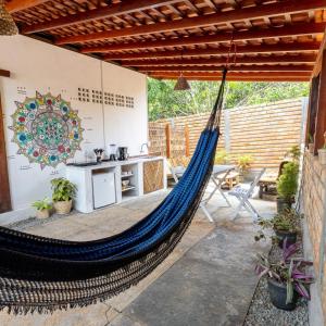 a hammock in a patio with a kitchen at Casa aloha in Atins