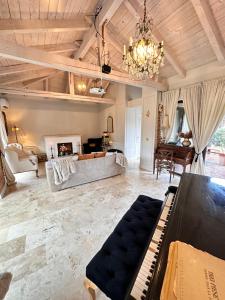 a living room with a piano and a couch at CHERRY VINTAGE HOME in Târgovişte