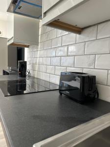 a toaster sitting on a counter in a kitchen at Studio Flat in Luton Town Centre in Luton