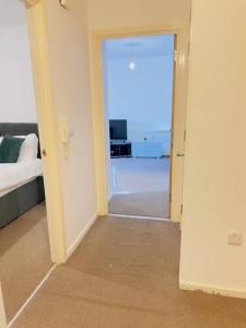 a room with a door open to a room with a bedroom at Starview Apartment-Vitoria in Lexden
