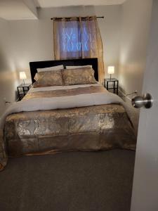Un dormitorio con una cama grande con una manta grande en Furnished rooms close to U of A in Edmonton, en Edmonton