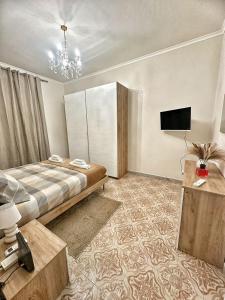 a bedroom with a bed and a flat screen tv at Maison Grimaldi Roma in Rome +11 photos