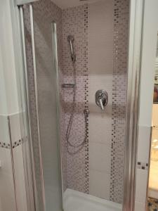 a shower with a shower head in a bathroom at Appartamento sul lungomare in centro Ladispoli in Ladispoli