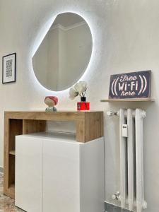 a dressing table with a mirror on a wall at Maison Grimaldi Roma in Rome