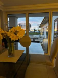 a vase of flowers on a table in a room at Islandon House The Jurassic Coast in Hamworthy