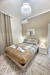 a bedroom with a bed with two towels on it at Maison Grimaldi Roma in Rome