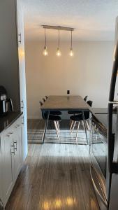 a dining room with a table and chairs in a kitchen at Cosy Private Room in Downtown with Free Parking - Self entrance in Calgary