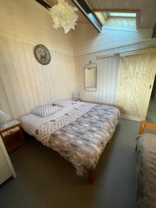 a bedroom with a large bed in a room at Les Cachettes du Hérisson - Le Hérissonneau in Le Frasnois