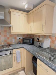 a kitchen with a counter top with a microwave at Starview Apartment 101 in Colchester