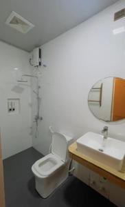 a bathroom with a toilet and a sink at Sandy Heaven Maldives in Gulhi