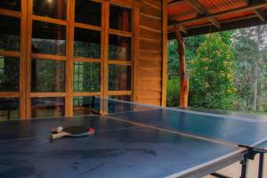 a ping pong table in front of a house at Finca La Unión in Turrialba