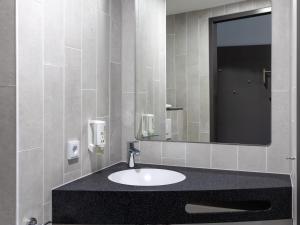 a bathroom with a sink and a mirror at B&B HOTEL Bad Hersfeld in Bad Hersfeld