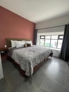 a bedroom with a bed and a large window at Quinta La Perla in Guadalajara +68 photos