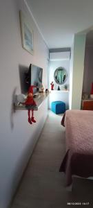 a bedroom with a bed and a shelf with a doll at MarilidiaHouse in Kardhoulianós