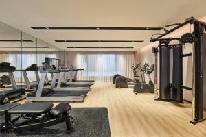 a gym with several treadmills and machines in a room at Fairfield by Marriott Changsha Tianxin in Changsha