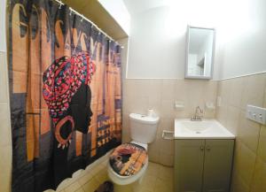 a bathroom with a toilet and a sink at Traveler's Lodge In Newark City in Newark