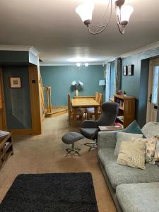 a living room with a couch and a table at Ivy House, three bed cottage, parking garden in Skipsea
