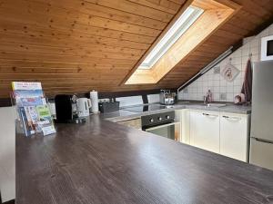 a kitchen with a wooden ceiling and a counter top at Ferienwohnung Löchgau in Löchgau