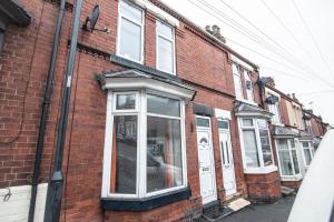 a brick building with a window on a street at Captivating 3-Bed House in Doncaster in Doncaster