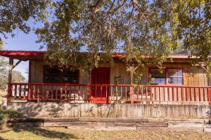 a house with a red door and a fence at Hi-Line Resort in Tow