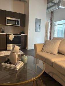 a living room with a couch and a glass table at Downtown Studio Apartment in San Diego