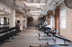 a gym with rows of exercise bikes and tread machines at Downtown Studio Apartment in San Diego