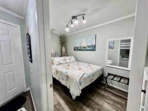a small bedroom with a bed and a mirror at Casa Del Marlin - Your Beach Retreat on Galveston Island, TX in Galveston +47 photos