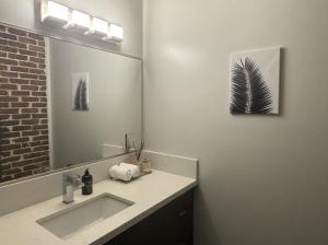 a bathroom with a sink and a mirror at Downtown Studio Apartment in San Diego