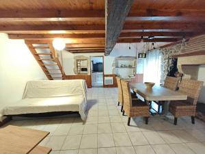 a bedroom with a bed and a table and chairs at Logement entier style chalet - 1 à 5 pers - in Langon