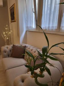 een woonkamer met een bank en een plant bij Panormus Apartment in Palermo