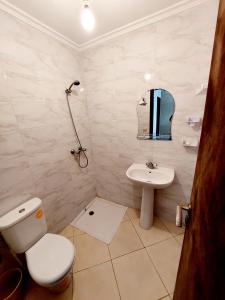 a bathroom with a toilet and a sink at Nador Holidays in Nador