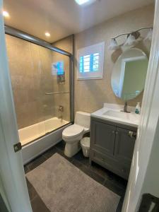 a bathroom with a toilet and a sink and a shower at Newly remodeled condo in Groveland