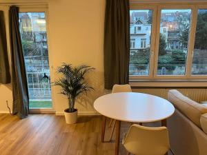 a living room with a table and a couch at Beautiful Flat in Etterbeek in Brussels