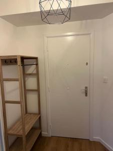 a room with a white door and a wooden shelf at Beautiful Flat in Etterbeek in Brussels