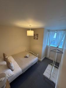 a bedroom with a bed and a window at Charming 2-Bedroom Retreats in Axminster