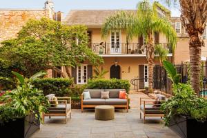 a patio with a couch and chairs in front of a house at W New Orleans - French Quarter in New Orleans