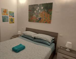 a bedroom with a bed with a painting on the wall at The Smart Choice Apartments in Florence